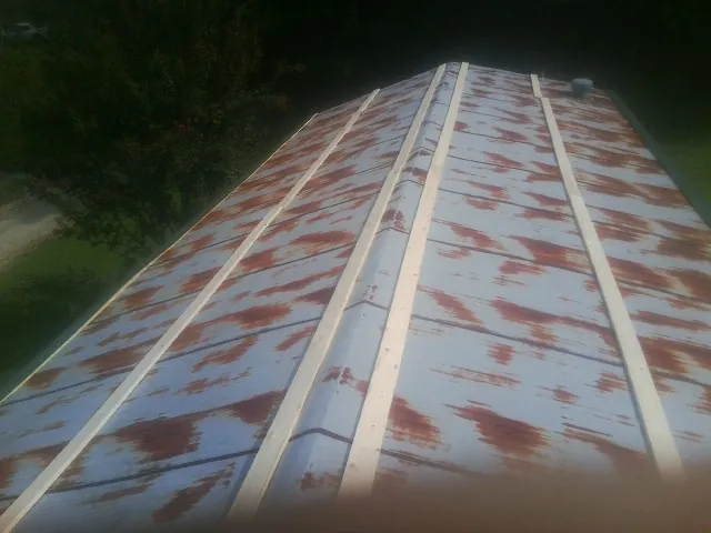 Rusted metal roof panels with new wood purlins before replacement — Storm Damage Roof Repair in Bern by Roofing Brothers